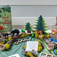Forest Invitation to Play learning collection with wooden animals, trees, and story materials arranged in a nature-inspired scene
