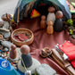 Children’s invitation to play with wooden figures, cave shelter, river fabric, and salmon storytelling setup for Indigenous-inspired learning