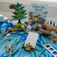 Ocean Invitation to Play learning collection showing full set of materials including wooden waves, figures, storytelling book, and hands-on resources for land-based learning in early years classrooms